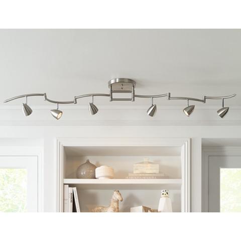 Fixture with track heads lighting a bookcase