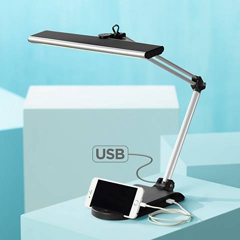 An LED desk lamp with a USB port and phone cradle. 